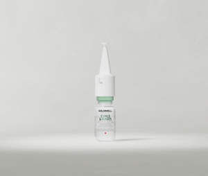 Goldwell Dualsenses Curls & Waves Intensive Restoring Spray pointed-tip bottle standing upright on a soft light grey studio background.