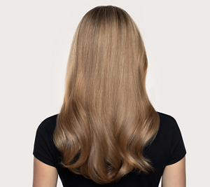 Goldwell Dualsenses Rich Repair after image showing a person from behind with long smoother blonde hair and soft waves against a neutral studio background.