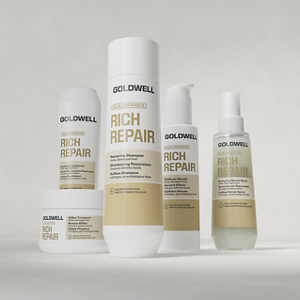 Goldwell Dualsenses Rich Repair haircare products shown as shampoo, conditioner, treatment and serum packaging arranged together on a light grey studio background.