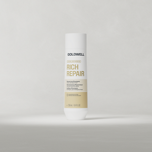 Goldwell Dualsenses Rich Repair Shampoo 250 ml bottle standing upright on a soft light grey studio background.