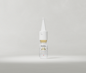 Goldwell Dualsenses Rich Repair Intensive Restoring Serum ampoule standing upright on a soft light grey studio background.