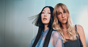  Goldwell Elumen campaign image featuring two models with blonde and dark hair in an editorial setting