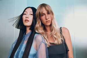 Goldwell Dualsenses trends carousel image featuring two models with styled hair in blue-toned editorial setting