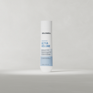 Goldwell Dualsenses Ultra Volume Shampoo 250 ml bottle standing upright on a soft light grey studio background.