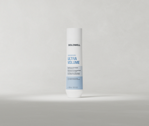 Goldwell Dualsenses Ultra Volume Shampoo 250 ml bottle standing upright on a soft light grey studio background.