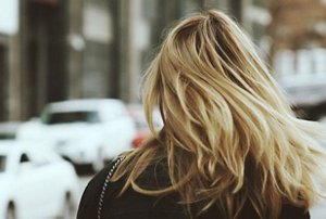 Woman with lush, naturally-thick sun-kissed blonde hair