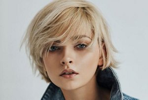 Blonde woman with a bixie cut with choppy layers