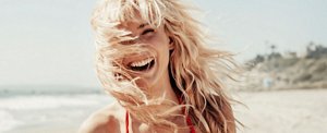 Happy woman with bleached hair on the beach