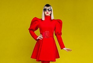 Woman in a red dress with a blonde bob with a fringe