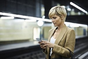 Woman on her phone waiting for a subway train