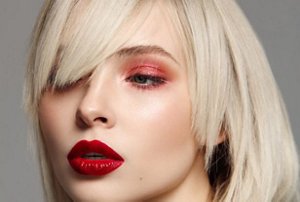 Woman with a blonde bob with a sideswept fringe