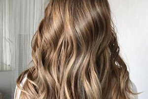 Woman with long, wavy hair after blow-drying it