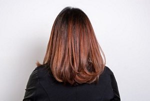 Redheaded woman with a blow-dried mid-length hairstyle