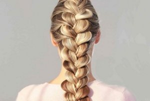 Woman with long, thick hair styled in a pull-through braid