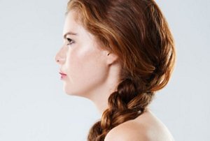 Young redheaded woman with a side braid