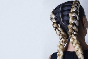 Woman with brunette and blonde hair in Dutch braids