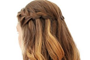 Woman with light auburn hair in a waterfall braid