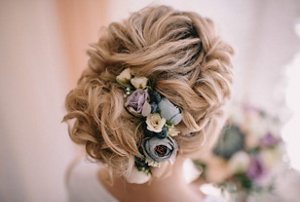 Bride with a neatly-styled wavy bun updo