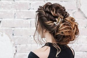 Brunette bridesmaid with a voluminous romantic braided bun