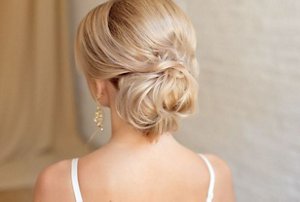 Blonde bridesmaid with a chignon hairstyle