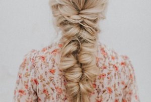 Blonde woman with fishtail braid hairstyle