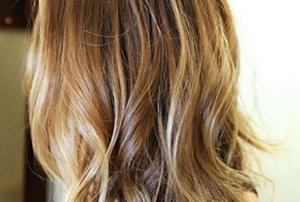 Woman with long honey brown hair with highlights