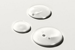 Drops of hair serum against a white background