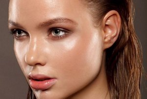 Woman with a slicked-back, wet-look hairstyle