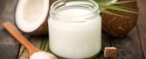 Close-up of a bottle of coconut oil on a wooden table