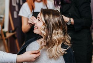 Smiling woman with long, balayaged hair