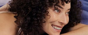 Smiling woman with well-defined, healthy-looking curls