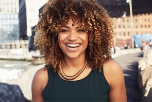 Smiling woman with type 4A curly hair