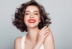 Brunette woman with short hair styled with corkscrew curls
