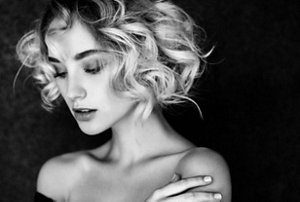 Blonde woman with a tousled curly blonde bob