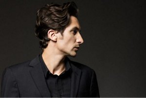 Man with slicked back short curly hair