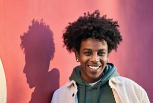 Smiling man with a classic afro haircut