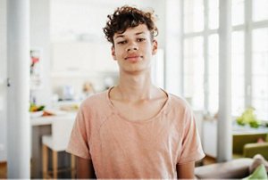 Young man with mid-length curls with a faded undercut
