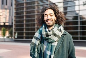 Smiling man with grown-out, mid-length curls