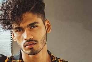 Young man with neatly-bundled curls and an undercut