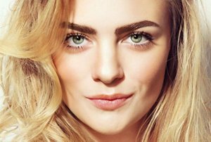 Smiling young woman with warm dirty blonde hair