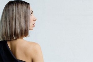 Woman with beige blonde dirty blonde hair cut into a blunt bob