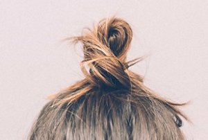 Brunette woman with her hair in a topknot