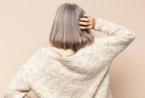 Woman with lightly-highlighted natural grey hair
