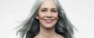 Radiant, smiling woman with long, natural grey hair