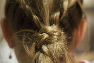 Close-up of a French plait made with a centre parting
