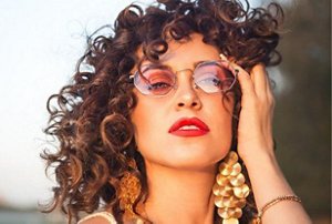 Woman with curly hair having fun at a festival