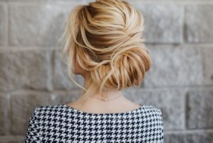 Blonde woman with a French twist updo hairstyle
