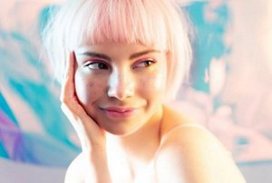Woman with light pink hair with a micro fringe
