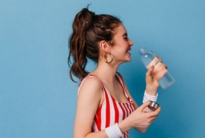 Young brunette woman with messy high ponytail hairstyle
