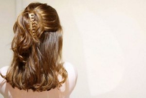 Brunette woman with a half up, half down hairstyle